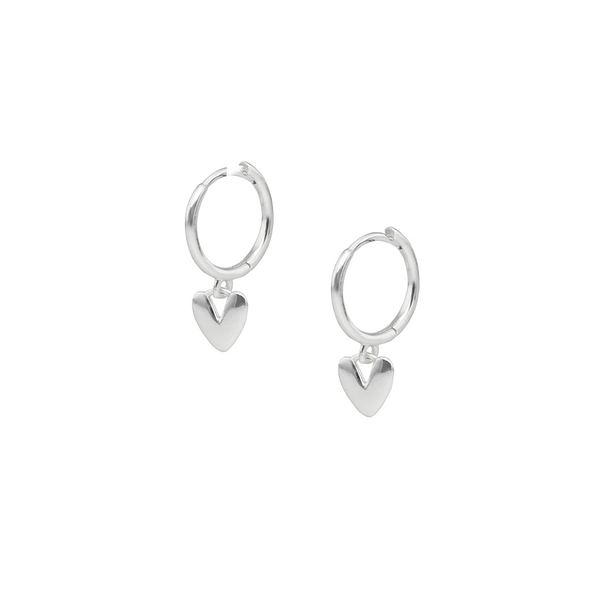 Silver heart-shaped huggie earrings on a white background